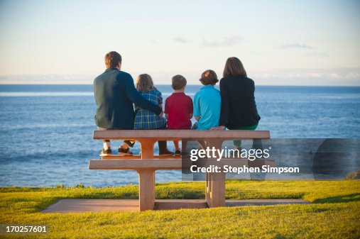 family on picnic bench by the ocean