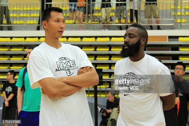 Yi Jianlian and American professional basketball player James Harden of Houston Rockets in action during a meeting with fans on June 8, 2013 in...