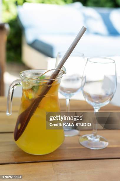 glass and jar of yellow sangria in a table outdoors - punching glass stock pictures, royalty-free photos & images