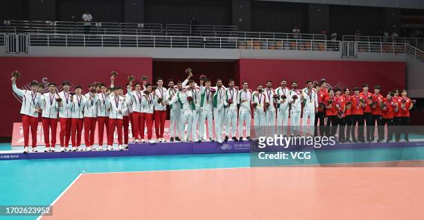 Silver medalists Team China, gold medalists Team Iran and bronze medalists Team Japan pose during the medal ceremony for the Volleyball - Men's Final...