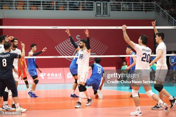 Players of Team Iran celebrate victory after defeating Team China in the Volleyball - Men's Final on day three of the 19th Asian Games at Linping...