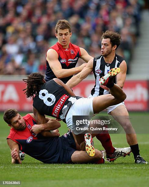 Mark Jamar of the Demons tackles Heritier O'Brien of the Magpies during the round 11 AFL match between the Melbourne Demons and the Collingwood...