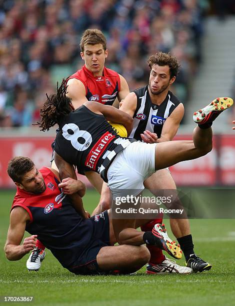 Mark Jamar of the Demons tackles Heritier O'Brien of the Magpies during the round 11 AFL match between the Melbourne Demons and the Collingwood...