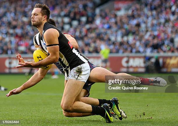 Nathan Brown of the Magpies marks infront of Chris Dawes of the Demons during the round 11 AFL match between the Melbourne Demons and the Collingwood...