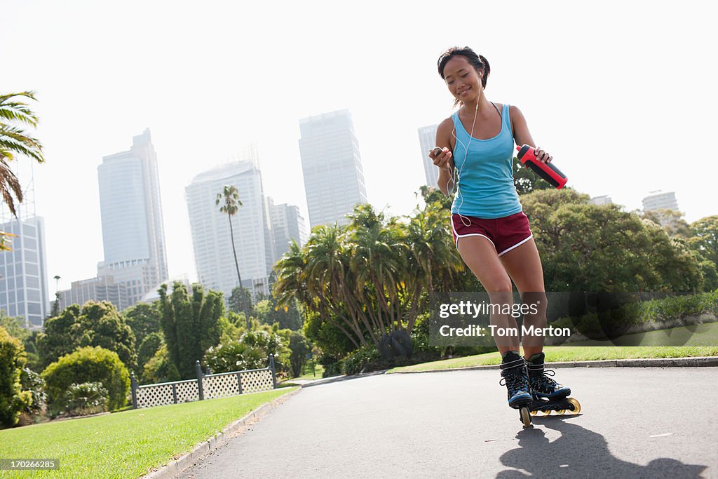 Mujer con patines en línea en relación con reproductor de mp3