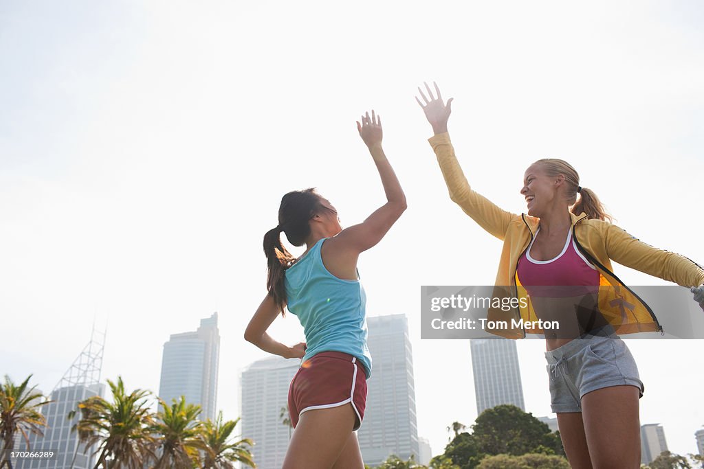Women on inline skates high fiving