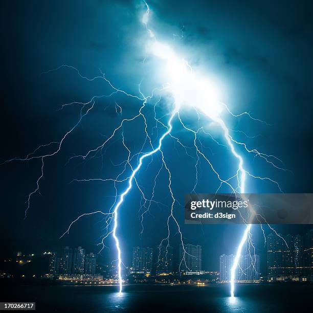 powerful lightning striking from sky to sea - lightning stockfoto's en -beelden