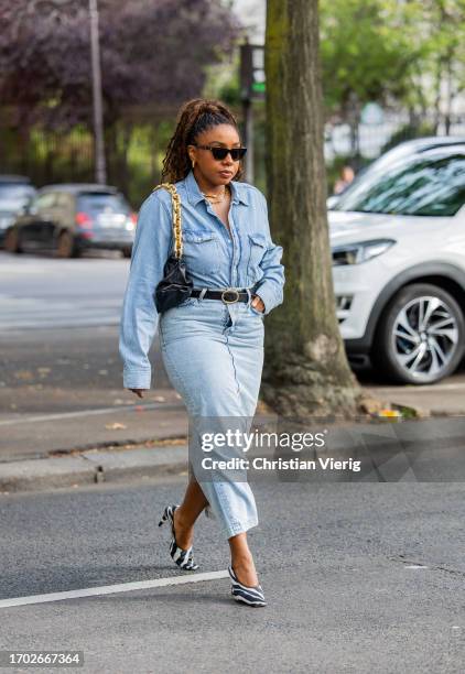 Lindsay Peoples Wagner wears denim shirt, skirt, zebra print heels, black bag outside Peter Do during the Womenswear Spring/Summer 2024 as part of...