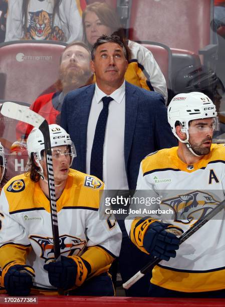 Head coach Andrew Brunette of the Nashville Predators watches a replay during second period action against the Florida Panthers during a preseason...