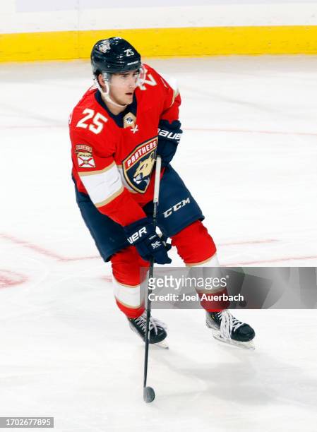 Mackie Samoskevich of the Florida Panthers skates with the puck against the Nashville Predators during a preseason game at the Amerant Bank Arena on...