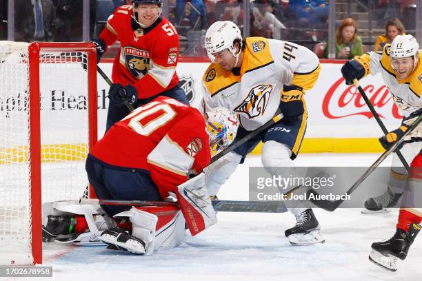 Goaltender Spencer Knight of the Florida Panthers stops a shot by Kiefer Sherwood of the Nashville Predators during a preseason game at the Amerant...
