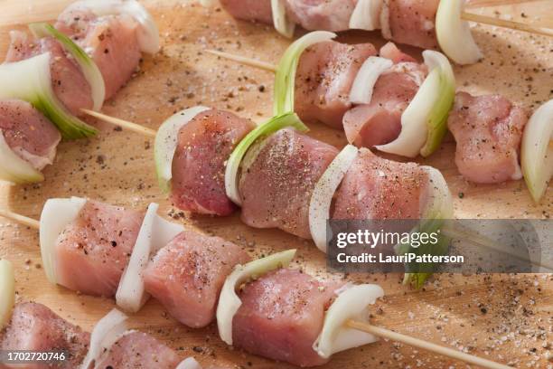 preparing pork kebabs - shish kebab stock pictures, royalty-free photos & images