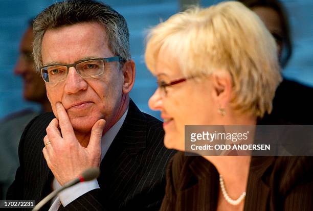 German Defence Minister Thomas de Maiziere is seated next to committee chairperson Susanne Kastner prior to be questioned during a German parliament...
