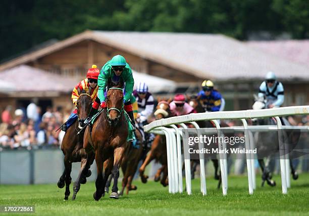 Frantic Storm ridden by Andreas Helfenbeinon leads the field into the first turn in the Preis der Lotterie Spiel 77 during the Lotto Festival 2013 at...