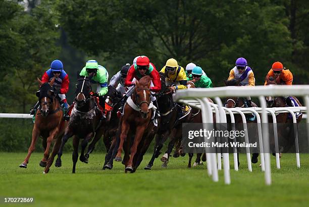 Arizona Desert ridden by Adrie de Vries leads the field in the Munich Polo Center- Rennen during the Lotto Festival 2013 at Galopp Munich on June 9,...