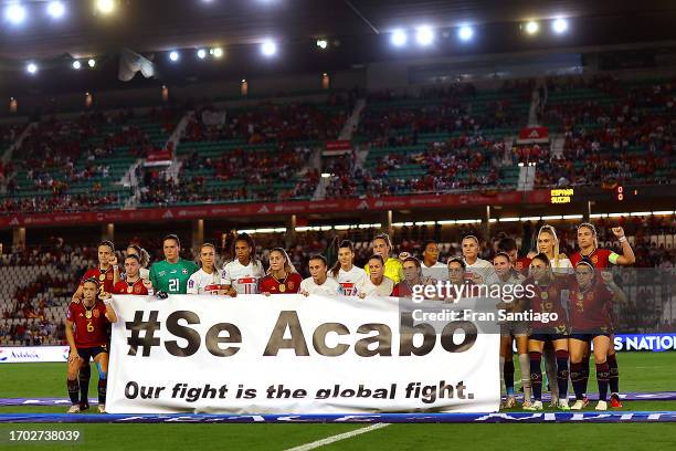Switzerland and Spain players hold a banner which reads 'Se Acabo, Our fight is the global fight.' in support of the Spain national women's team...