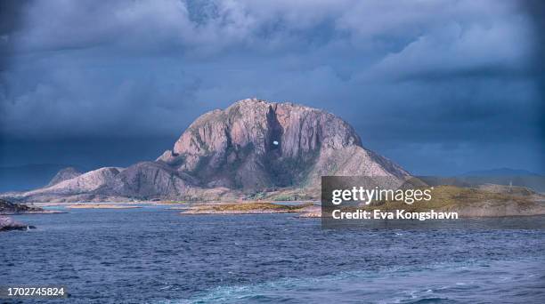 a mountain with a hole through to the other side - bay of water stock pictures, royalty-free photos & images