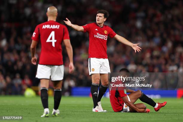 Harry Maguire of Manchester United reacts as teammate Anthony Martial goes down with an injury during the Carabao Cup Third Round match between...