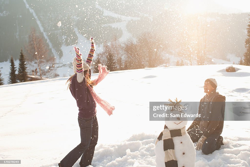 Couple having snowball fight