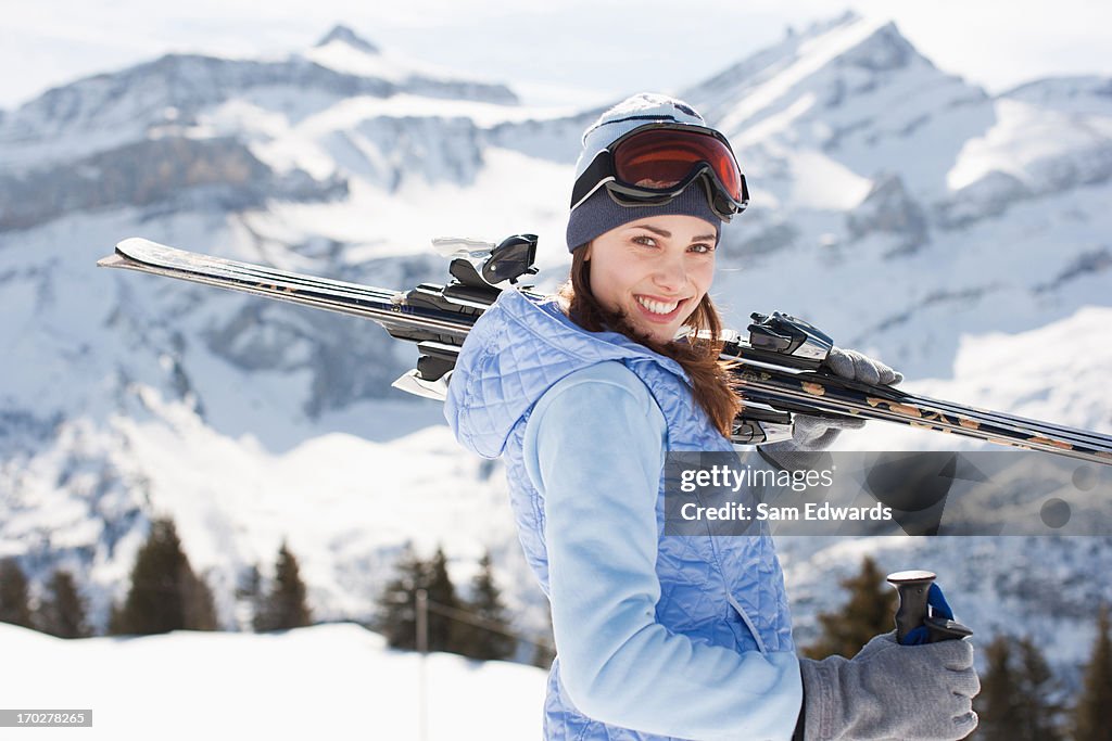 Woman carrying skis