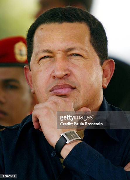 President Hugo Chavez listens to a speech at a fuel distribution plant located 93 miles east of Caracas December 27, 2002 in Carenero, Venezuela....