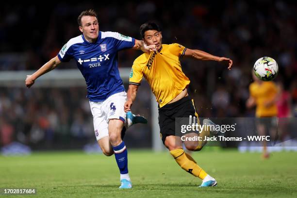 Hee-chan Hwang of Wolverhampton Wanderers battles for possession against George Edmundson of Ipswich Town during the Carabao Cup Third Round match...