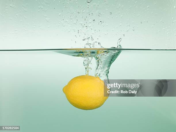 lemon splashing in water - sink stock pictures, royalty-free photos & images