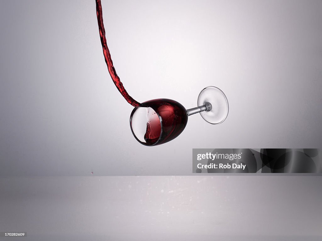 Red wine pouring into glass