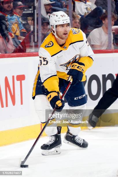 Roland McKeown of the Nashville Predators xclears the puck from behind the net against the Florida Panthers during a preseason game at the Amerant...