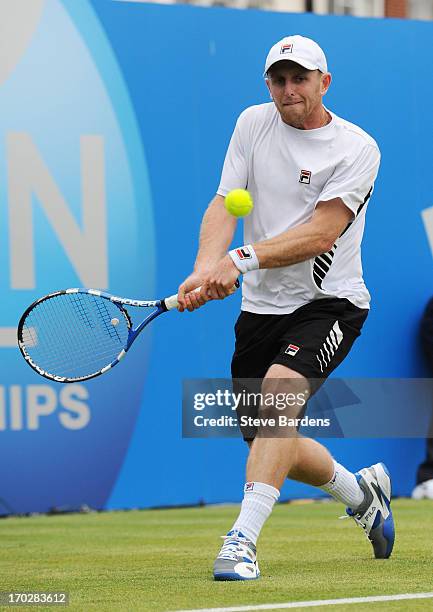 Jesse Levine of Canada hits a backhand during his Men's Singles first round match against Santiago Giraldo of Colombia on day one of the AEGON...