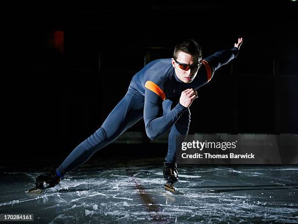 Long track speed skater racing on track in arena