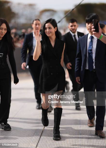 Jisoo of Blackpink is seen wearing a complete outfit from Christian Dior, consisting of a sleeveless, black wool, mini dress with lapel collar and...