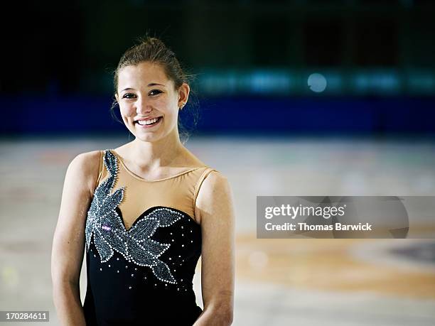 smiling female figure skater standing on ice - grand prix of figure skating skate canada international stockfoto's en -beelden