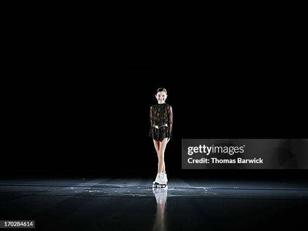 smiling young female figure skater standing on ice - figure skating girl stock pictures, royalty-free photos & images
