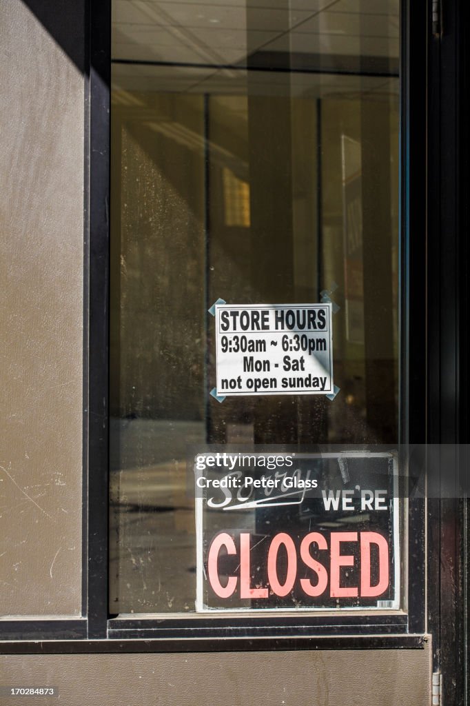 "Sorry We're Closed" sign in a building's window