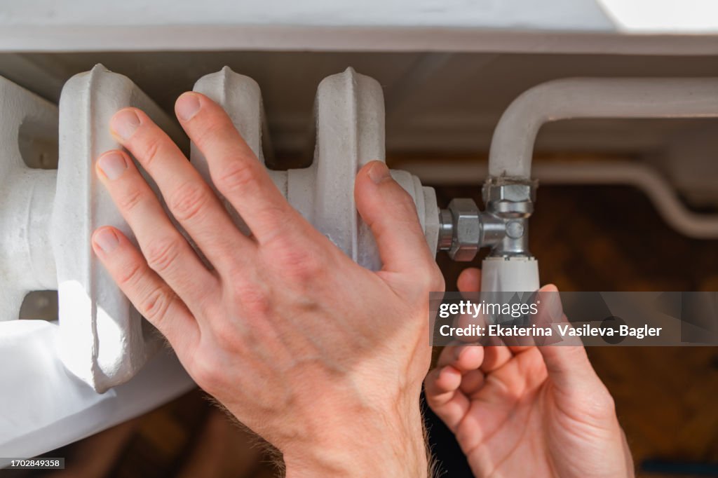 Handcuffed To Radiator Unrecognizable Man Hands Touching And Setting Radiator Thermostat ...