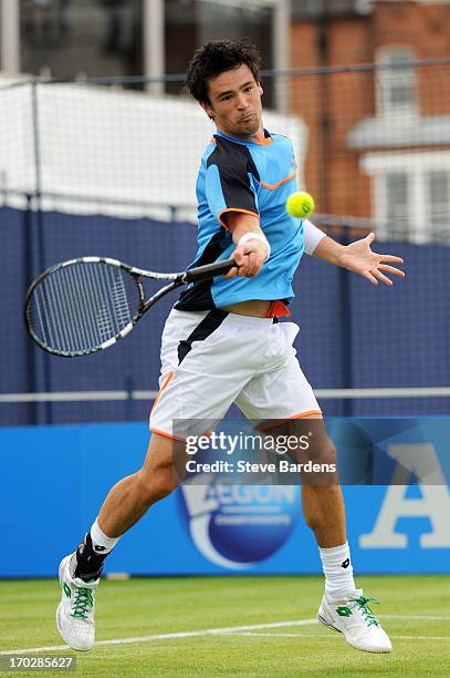 Jamie Baker of Great Britain hits a forehand shot during his Men's Singles first round match against Benoit Paire of France on day one of the AEGON...