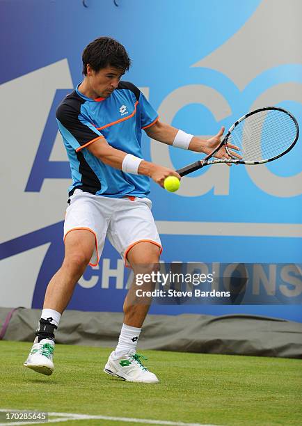 Jamie Baker of Great Britain hits a backhand shot during his Men's Singles first round match against Benoit Paire of France on day one of the AEGON...