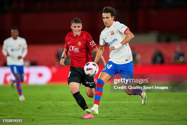Giovanni Gonzalez of RCD Mallorca competes for the ball with Joao Felix of FC Barcelona during the LaLiga EA Sports match between RCD Mallorca and FC...