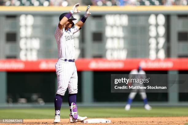 Ezequiel Tovar of the Colorado Rockies gestures to the dugout after hitting a double against the Los Angeles Dodgers in the second inning during Game...