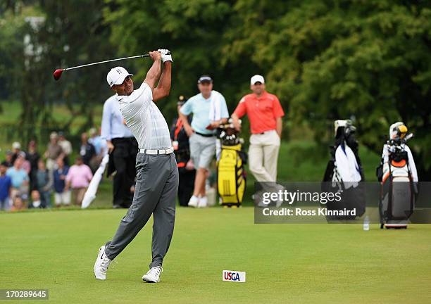 Tiger Woods of the United States hits a shot on the 14th teeas Sergio Garcia of Spain looks on during a practice round prior to the start of the...