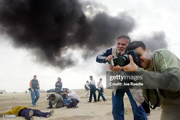 Journalists document a Civil Defense Authority mock chemical attack December 28, 2002 in Kuwait City, Kuwait. The Civil Defense Center continues to...