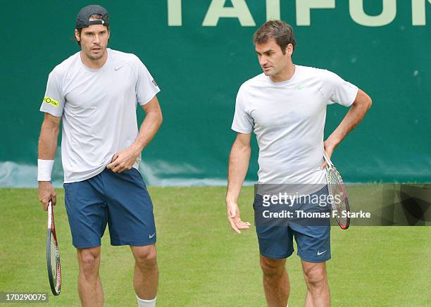 Tommy Haas Germany and Roger Federer of Switzerland look dejected during their first round doubles match against Jurgen Melzer of Austria and Philipp...