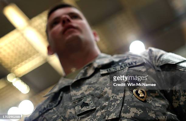 Army Sgt. Sean P. Karpf stands with his recently awarded Purple Heart during a ceremony at Mount Vernon June 10, 2013 in Mount Vernon, Virginia. The...