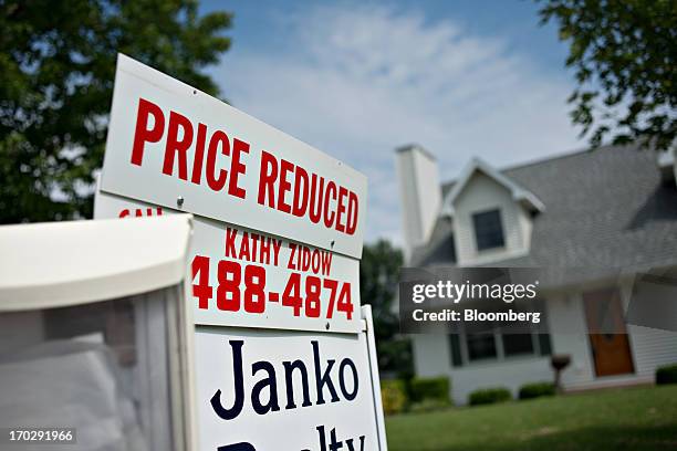 Price reduced" sign stands outside a home for sale in Spring Valley, Illinois, U.S., on Friday, June 7, 2013. The Mortgage Bankers Associations...