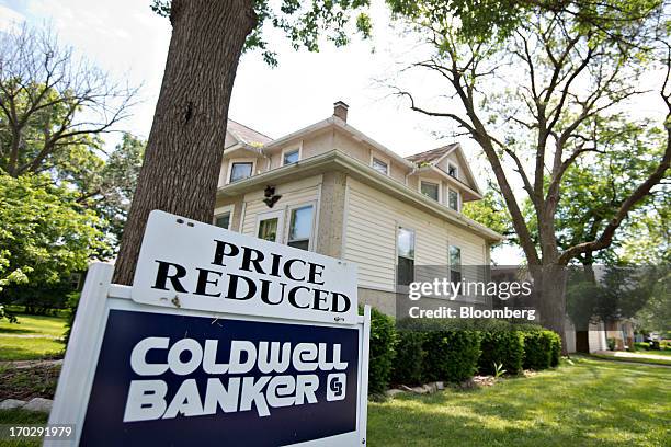 Price reduced" sign stands outside a home for sale in LaSalle, Illinois, U.S., on Friday, June 7, 2013. The Mortgage Bankers Associations weekly...