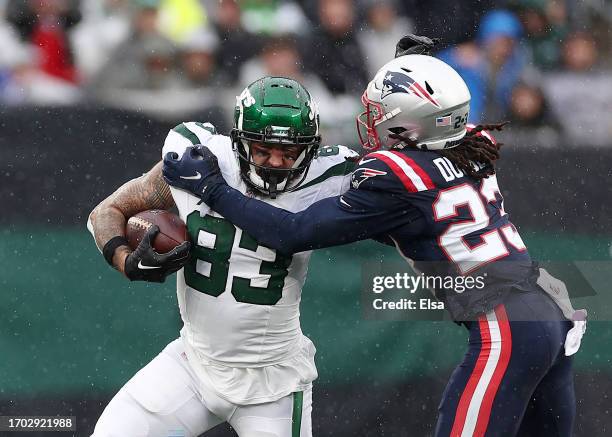 Tyler Conklin of the New York Jets carries the ball as Kyle Dugger of the New England Patriots makes the stop at MetLife Stadium on September 24,...