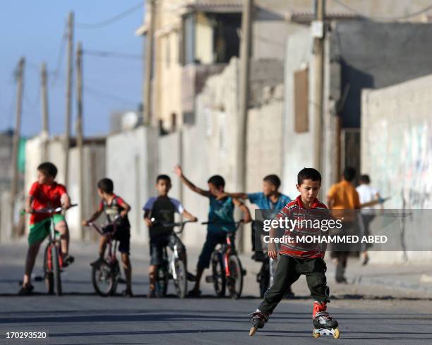 Palestinian boy plays on his roller-blades in the Shati refugee camp in Gaza City on March 29, 2013. AFP PHOTO/MOHAMMED ABED