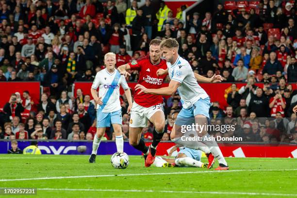 Jonny Evans of Manchester United competes for the ball with Rob Holding of Crystal Palace during the Carabao Cup Third Round match between Manchester...