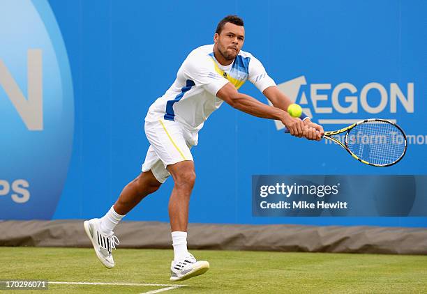 Jo Wilfried Tsonga of France plays a backhand shot during his Men's Doubles first round match with Nicholas Mahut of France against Jarkko Nieminen...